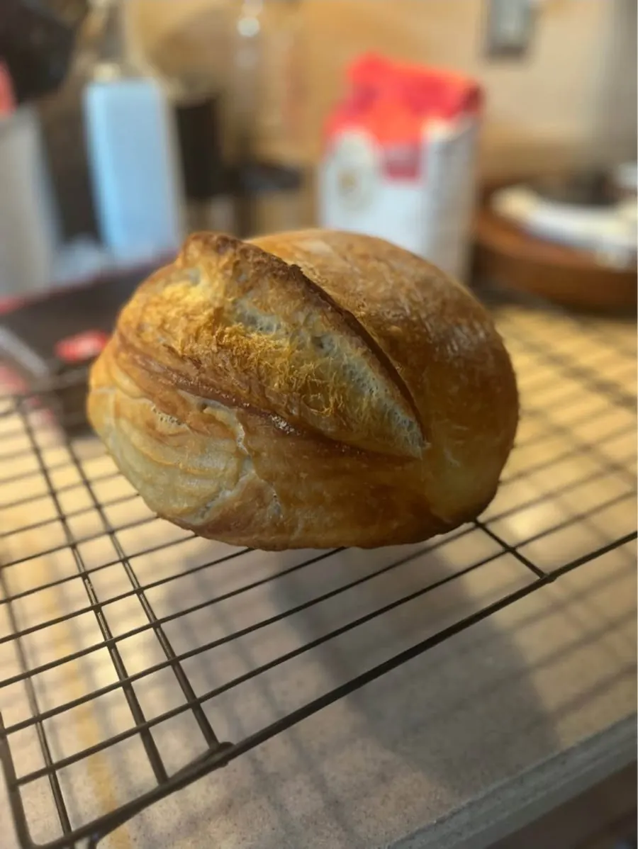 Sourdough loaf cooling on a wire rack